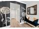 Hallway with black accent wall and dandelion wall paper, designer mirror, and accent bench at 174 Golden Gate Pt # 21, Sarasota, FL 34236
