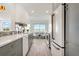 Modern kitchen featuring new cabinets, a tile backsplash, quartz countertops and stainless appliances at 174 Golden Gate Pt # 21, Sarasota, FL 34236