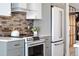 Close up of kitchen with sleek stainless appliances, contemporary cabinetry, and stylish backsplash, a culinary dream at 174 Golden Gate Pt # 21, Sarasota, FL 34236