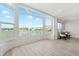 Spacious living room with large windows offering panoramic views of the water and blue skies at 174 Golden Gate Pt # 21, Sarasota, FL 34236