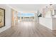 Spacious living room with luxury vinyl floors, large windows offering panoramic water views, and recessed lighting at 174 Golden Gate Pt # 21, Sarasota, FL 34236