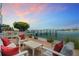 Inviting outdoor seating area with comfortable chairs, pillows, and scenic waterfront views, perfect for relaxing at 174 Golden Gate Pt # 21, Sarasota, FL 34236