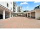 Open parking area showcases brick pavers and covered parking at 174 Golden Gate Pt # 21, Sarasota, FL 34236
