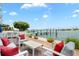 Waterfront patio featuring outdoor seating with pier and water views at 174 Golden Gate Pt # 21, Sarasota, FL 34236