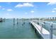 Scenic view of a white wooden pier extending into the calm water with a distant bridge at 174 Golden Gate Pt # 21, Sarasota, FL 34236