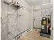 Well-organized utility room with shelving and water heater at 174 Golden Gate Pt # 21, Sarasota, FL 34236