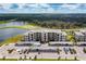 An aerial view of the condo complex with a pond, golf course and covered parking at 18114 Gawthrop Dr # 201, Bradenton, FL 34211