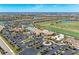 Expansive aerial view of the community clubhouse, pool, and tennis courts surrounded by lush landscaping at 18114 Gawthrop Dr # 201, Bradenton, FL 34211