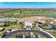 Stunning aerial view of the clubhouse and pool area with a well-manicured golf course backdrop at 18114 Gawthrop Dr # 201, Bradenton, FL 34211