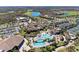 Extensive aerial view showcasing the community pool, clubhouse, and tennis courts in a Primary-planned community at 18114 Gawthrop Dr # 201, Bradenton, FL 34211