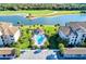 This aerial view showcases a pool with an accompanying outdoor kitchen surrounded by residences at 18114 Gawthrop Dr # 201, Bradenton, FL 34211