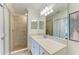 Bathroom featuring a glass shower, and a spacious vanity with a mirror at 18114 Gawthrop Dr # 201, Bradenton, FL 34211