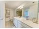 Bathroom boasts dual sinks, large mirrors, and a separate shower room at 18114 Gawthrop Dr # 201, Bradenton, FL 34211