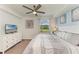 Charming bedroom features a king bed, neutral decor, and sun-filled window at 18114 Gawthrop Dr # 201, Bradenton, FL 34211