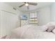Bedroom featuring a large window, TV, ceiling fan, and ample closet space at 18114 Gawthrop Dr # 201, Bradenton, FL 34211
