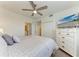 Bedroom with TV, ceiling fan, and access to the ensuite bathroom and closet at 18114 Gawthrop Dr # 201, Bradenton, FL 34211