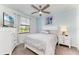 Cozy bedroom with a ceiling fan, large window, and white furniture at 18114 Gawthrop Dr # 201, Bradenton, FL 34211