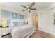 Bright bedroom boasts a ceiling fan, ensuite bathroom, and stylish décor at 18114 Gawthrop Dr # 201, Bradenton, FL 34211