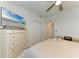 The bedroom features a ceiling fan, a dresser with a television, and a double door closet at 18114 Gawthrop Dr # 201, Bradenton, FL 34211
