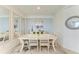 Dining room with table, chairs, buffet, and artwork, illuminated by natural light at 18114 Gawthrop Dr # 201, Bradenton, FL 34211