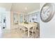 Dining room with white table, chairs, and decor on light blue wall at 18114 Gawthrop Dr # 201, Bradenton, FL 34211