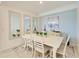Dining room with white table and chairs with a buffet and mirrors in the background at 18114 Gawthrop Dr # 201, Bradenton, FL 34211