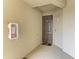 Condo entrance with dark gray door and fire extinguisher box on the wall at 18114 Gawthrop Dr # 201, Bradenton, FL 34211