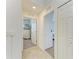 This hallway features neutral walls, tile and carpet flooring, and access to a bedroom and closet at 18114 Gawthrop Dr # 201, Bradenton, FL 34211