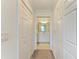 Hallway view of the neutral-toned bathroom with a white vanity at 18114 Gawthrop Dr # 201, Bradenton, FL 34211