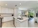 Bright, open-concept kitchen with an island, stainless steel appliances, and a view of the adjacent living room and balcony at 18114 Gawthrop Dr # 201, Bradenton, FL 34211