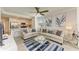 Stylish living room with modern furnishings, balcony access, and an open concept design to the kitchen at 18114 Gawthrop Dr # 201, Bradenton, FL 34211