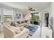 Inviting living room with natural light, comfortable seating, and a view of the kitchen area at 18114 Gawthrop Dr # 201, Bradenton, FL 34211