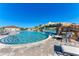 Resort-style pool with a waterfall feature, lounge chairs, and lush landscaping at 18114 Gawthrop Dr # 201, Bradenton, FL 34211