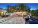 Inviting outdoor space featuring a paved patio, fire pit, palm trees, and stylish seating area with ambient string lights at 1934 Bougainvillea St, Sarasota, FL 34239