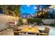 Charming backyard with paved patio, outdoor dining set, ambient string lights, and lush landscaping at 1934 Bougainvillea St, Sarasota, FL 34239