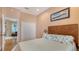 Cozy peach bedroom with hardwood floors, white closets, bed with decorative pillows and hallway entrance at 1934 Bougainvillea St, Sarasota, FL 34239