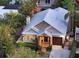Aerial view of a beautifully landscaped home featuring a metal roof, inviting entry and well-manicured yard at 1934 Bougainvillea St, Sarasota, FL 34239