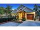 Charming home featuring a manicured front yard, a wooden door with wreath, and a single-car garage at 1934 Bougainvillea St, Sarasota, FL 34239