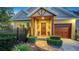 Inviting entryway with decorative plants, a brick walkway, and a wooden front door adorned with a wreath at 1934 Bougainvillea St, Sarasota, FL 34239