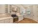 Kitchen featuring stainless steel appliances, white cabinets, and stainless hood at 1934 Bougainvillea St, Sarasota, FL 34239