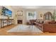 Cozy living room featuring a fireplace, plush seating, hardwood flooring, and a large decorative rug at 1934 Bougainvillea St, Sarasota, FL 34239