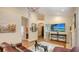 Bright living room with hardwood floors, a chandelier, and an entertainment center with a large-screen TV at 1934 Bougainvillea St, Sarasota, FL 34239