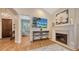 Open living room with fireplace, mounted TV, wood floors, and decorative painting above mantle at 1934 Bougainvillea St, Sarasota, FL 34239
