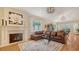 Elegant living room with hardwood floors, a fireplace, and a view of the dining area at 1934 Bougainvillea St, Sarasota, FL 34239