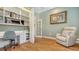 Office with built-in shelving, work desk, comfortable chair, and hardwood floors at 1934 Bougainvillea St, Sarasota, FL 34239