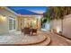 Outdoor patio with table, chairs, string lights, stone pavers, and access to interior via glass doors at 1934 Bougainvillea St, Sarasota, FL 34239