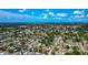 An aerial view showcasing the property's location within a lush, tree-filled neighborhood under a blue sky at 2004 19Th W St, Bradenton, FL 34205