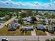 Aerial view of a single-story home in a suburban neighborhood with mature trees and well-maintained lawns at 2004 19Th W St, Bradenton, FL 34205