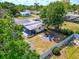 A private, fenced backyard with a fire pit and covered patio offers the perfect space for outdoor entertaining at 2004 19Th W St, Bradenton, FL 34205