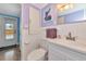 Updated bathroom with white tiling, modern sink, and access to the backyard at 2004 19Th W St, Bradenton, FL 34205